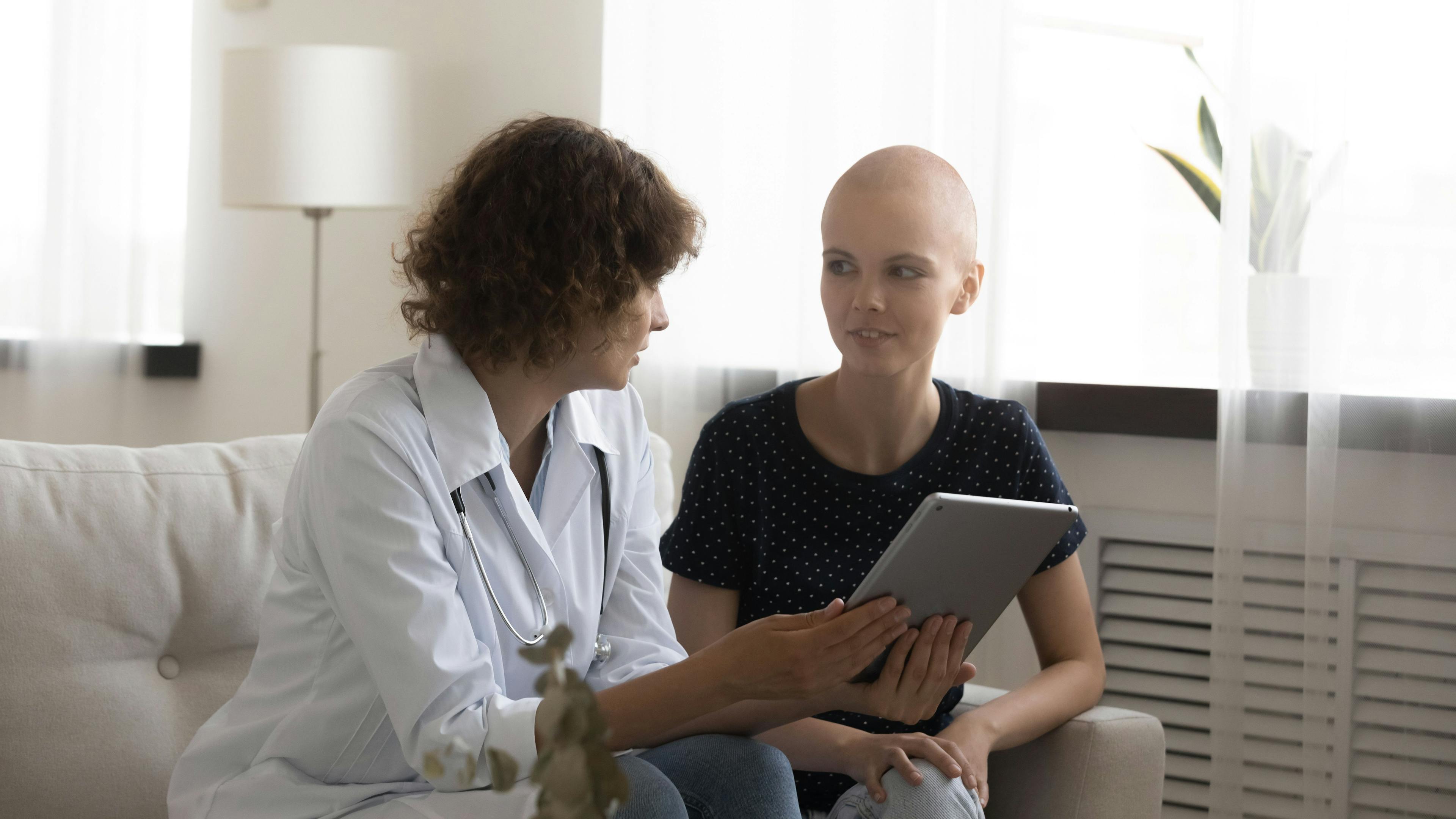 Confident doctor and woman patient discuss test results on pad screen on appointment at oncological center. Qualified physician explain treatment plan to young female sick with cancer using tablet pc: © fizkes - stock.adobe.com