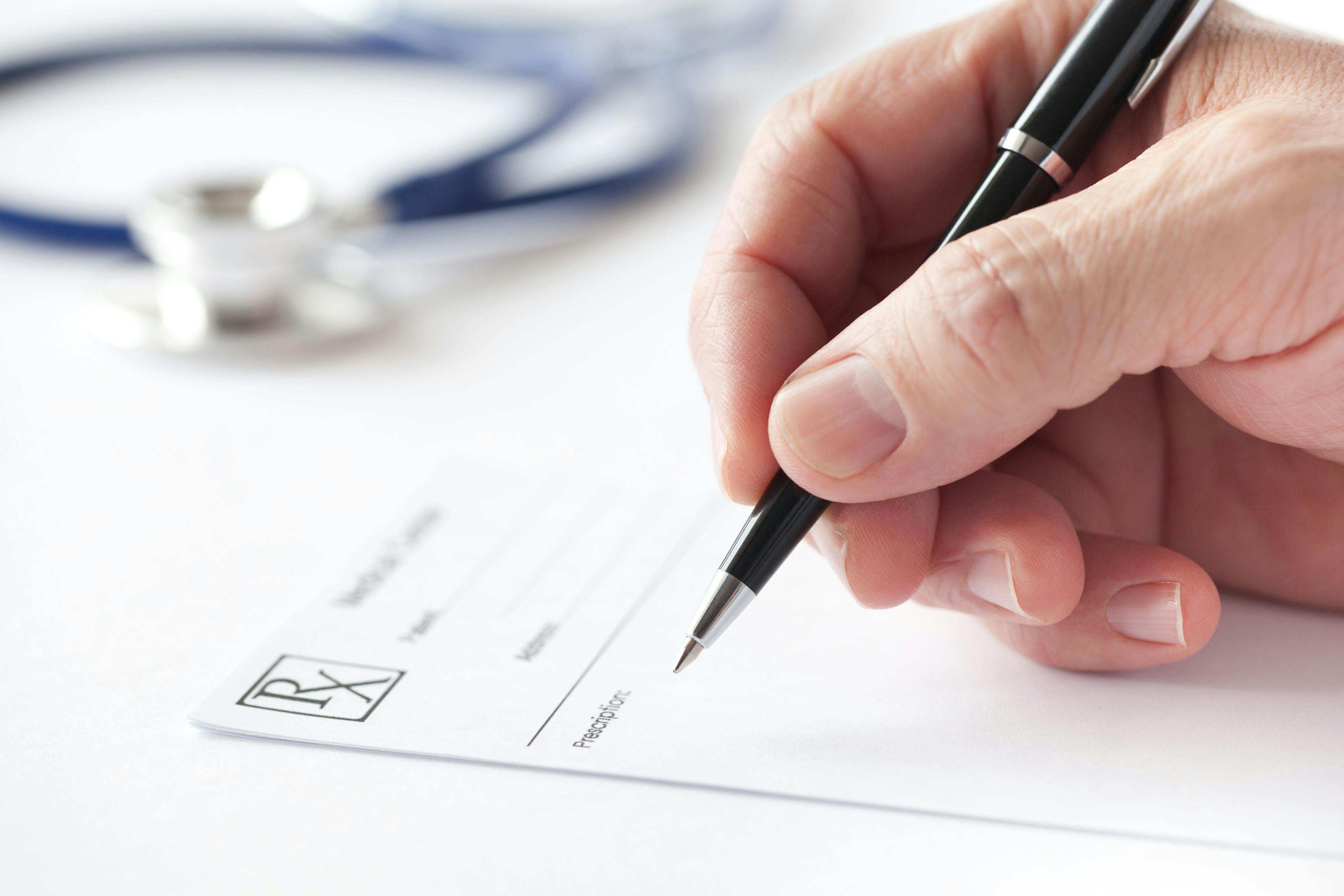 Doctor writing a prescription on Rx form in the consulting room: © omphoto - stock.adobe.com